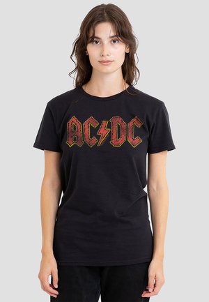 Black cotton t-shirt featuring "AC/DC" logo in red and yellow text with a lightning bolt, crew neck, and short sleeves.