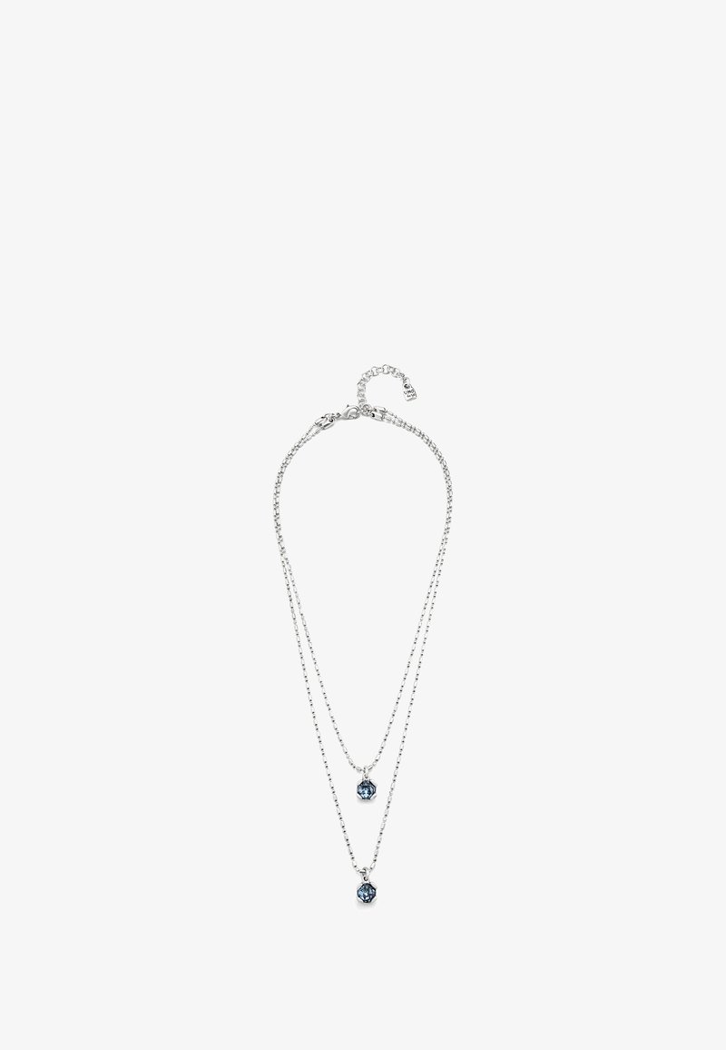 Collier à plusieurs couches en ton argent avec deux pendentifs, mettant en valeur des pierres précieuses bleues. Design de chaîne délicat, texture subtile et fermoir pour l'ajustement.