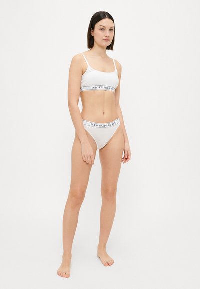 Light gray bralette and matching bikini set made of smooth fabric, featuring a contrasting waistband with "POLO RALPH LAUREN" text.