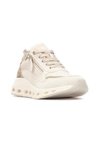 Zapatilla deportiva beige con parte superior texturizada, cordones en la parte delantera, cierre de cremallera y acentos brillantes en el talón. Detalles perforados a lo largo de los laterales.