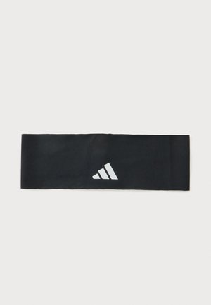 Czarna sportowa opaska materiałowa z białym logo Adidas na środku, pokazana na płasko na jasnym tle.