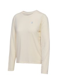 Chandail à manches longues de couleur crème en tissu doux. Il présente un col rond avec un petit logo bleu sur le côté supérieur gauche.