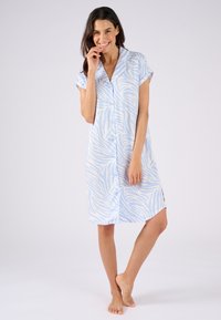 Camicia da notte blu chiaro fino al ginocchio con strisce bianche a zebra, maniche corte e chiusura frontale con bottoni. Tessuto liscio con spacchi laterali.