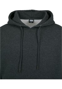 Tummaa harmaa huppari, jossa on nyörihuppu, pehmeä texture ja näkyviä ompelutaitoksia. Tunnuslukuna on "URBAN CLASSICS, M."