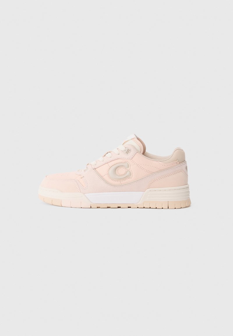 Light pink sneakers with a textured upper, rounded toe, and white accents. Features a cushioned sole and a prominent logo on the side.