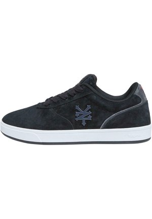 Black suede sneakers featuring a dark blue logo, round laces, and a white rubber sole with a textured finish. Simple and modern design.