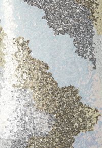 Lesklá tkanina s gradientem stříbrné, zlaté a béžové barvy na světle modrém pozadí, vytvářející abstraktní, texturovaný vzor.