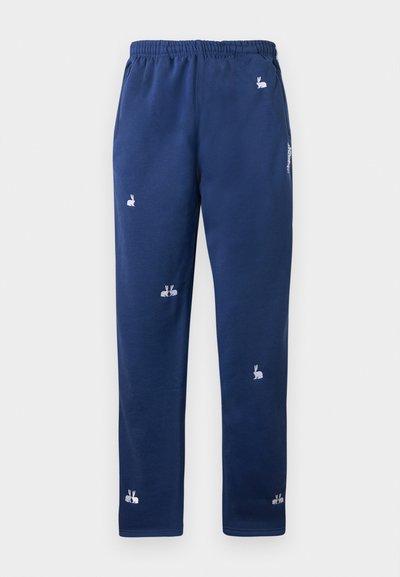 Navy blue sweatpants with an elastic waistband, featuring white rabbit embroidery details scattered across the fabric. Soft, smooth texture.