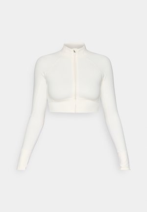 Bijela skraćena zip-up majica s dugim rukavima, visokim ovratnikom, uskim dizajnom, glatkom teksturom i rukavima s otvorima za palčeve.