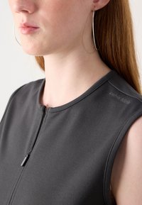Black sleeveless dress featuring a round neckline and front zip closure. Material is smooth with a slight sheen. Brand name visible on the shoulder.