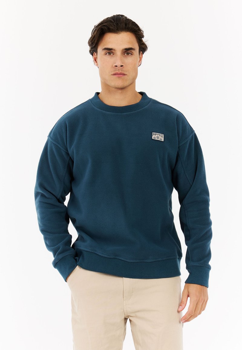 Blauwe fleece sweatshirt met een ronde hals, ribbels aan de mouwen en onderkant, voorzien van een klein logo op de linker borst. Gladde textuur.