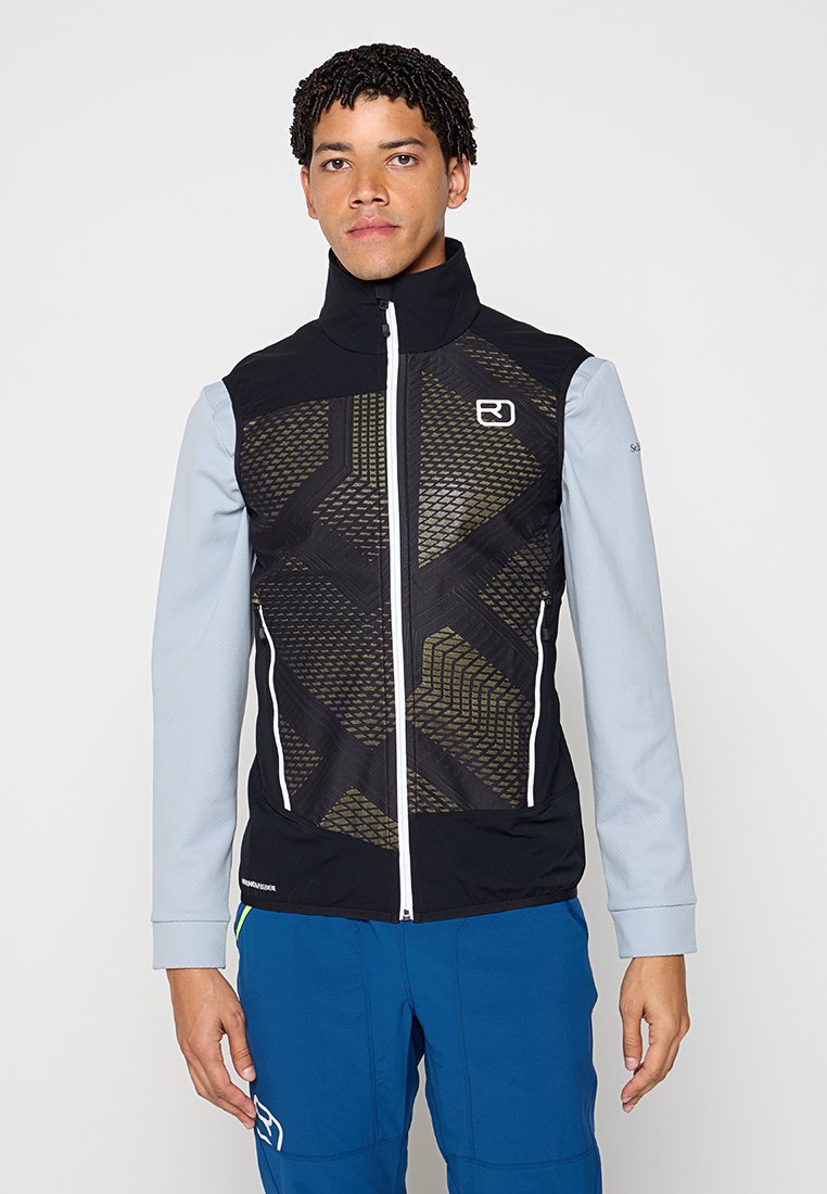 Schwarze ärmellose Jacke mit geometrischen Mustern in Dunkelgrün. Sie hat einen hohen Kragen, einen frontalen Reißverschluss und kontrastierende hellgraue Ärmel.