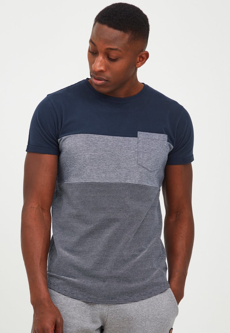 Navy and grey short-sleeve t-shirt featuring a pocket, with a textured striped lower section and solid upper section.