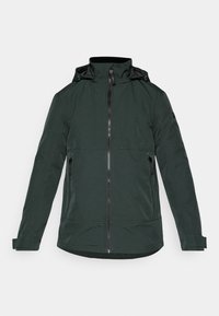 Donkergroene jas van gladde stof, met een hoge kraag, rits aan de voorkant en twee zijzakken met rits. Lange mouwen met cuffs.