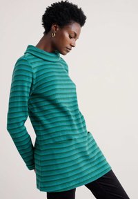 Zaļš striped turtlenecks džemperis ar teksturētu dizainu, garām piedurknēm un brīvu piegriezumu. Izgatavots no mīkstas, elastīgas auduma.