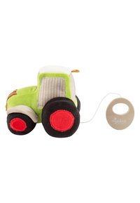 Soft plush green and beige toy tractor with black and red wheels, attached to a beige circular pull handle by a white string.