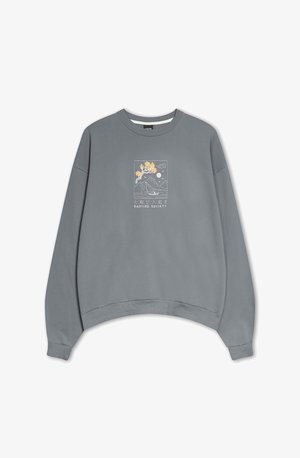 Grå oversized sweatshirt med et cropped design, der har et dekorativt grafisk motiv i gul og blå, der skildrer bjerge og træer.
