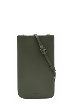 Dark green leather crossbody bag with smooth texture, minimalistic design, adjustable strap, and embossed logo detail at the bottom.