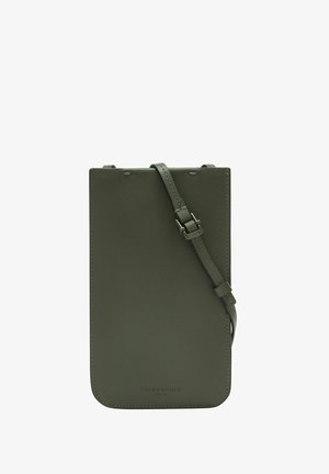 Dark green leather crossbody bag with smooth texture, minimalistic design, adjustable strap, and embossed logo detail at the bottom.