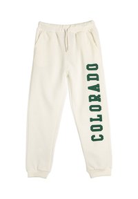Jasno kremowe spodnie dresowe z elastycznym paskiem, sznurkiem, bocznymi kieszeniami, ściągaczami na kostkach oraz zielonym pionowym napisem "COLORADO" na prawej nodze.