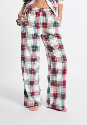 Pantalons de pyjama à carreaux en tissu doux et blanc, ornés de lignes rouges, vertes et bleues. Design à jambes larges avec poches et taille élastique.