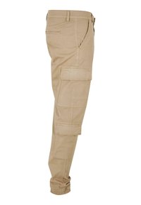 Beige Cargo-Hosen mit mehreren Seitentaschen, tailliertem Design, elastischen Bündchen und Baumwollmaterial. Glatte Textur und lässiger Stil.
