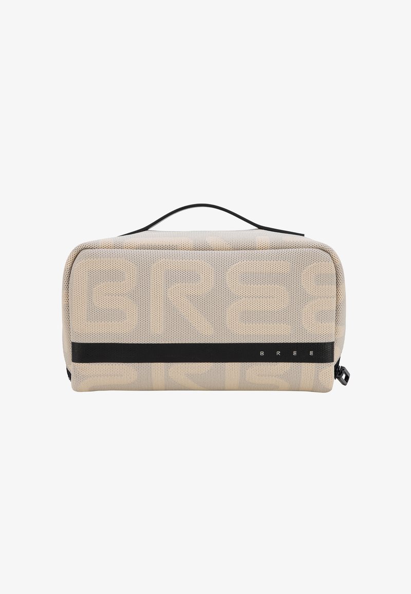 Trousse de toilette rectangulaire beige en mesh avec sangle horizontale noire, poignée supérieure, fermeture éclair et motif de grands textes discrets sur les côtés.