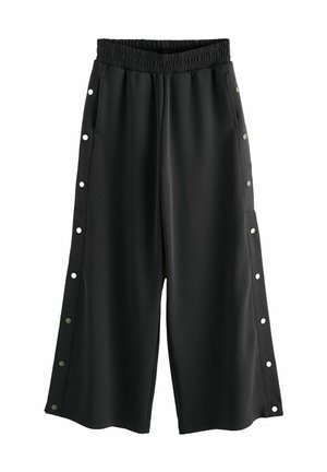 Culottes noirs avec une taille élastique, des poches latérales et des pressions le long des deux côtés pour un style ajustable.