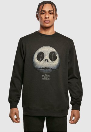 Black sweatshirt featuring a large Jack Skellington skull graphic with two figures inside and text reading "The Nightmare Before Christmas."