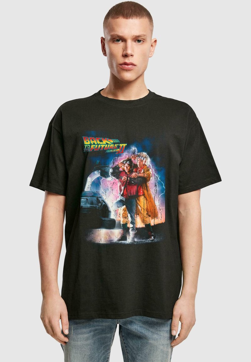 Black cotton t-shirt featuring a vibrant graphic print from "Back to the Future II," depicting characters and a car against a colorful background.