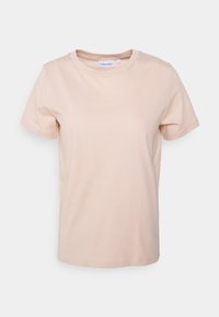 Calvin Klein short-sleeve t-shirt in soft peach cotton; crew neckline with subtle logo detail on the chest and standard fit.