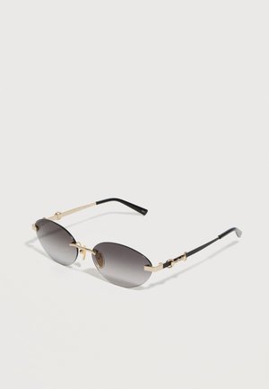 Γυαλιά ηλίου με φακούς γκρι σε σχήμα οβάλ με λεπτά μεταλλικά πλαίσια σε χρυσό και μαύρο και μαύρες άκρες στα κλαδάκια.