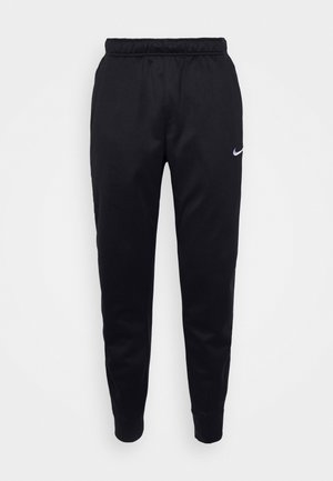 Svart Nike joggebukser med elastisk midjebånd, smale ben og diskret logo. Laget av glatt stoff med et enkelt design.