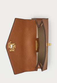 Tan leather handbag with a textured surface, gold hardware, and a clasp closure. Interior features light beige lining and a logo accent.