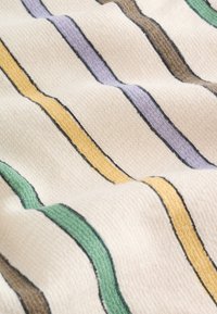 Tela crema con superficie texturizada que presenta rayas diagonales en verde, amarillo, morado y marrón delineadas por finas líneas negras.
