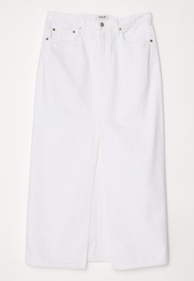 White denim skirt featuring a front slit, five-pocket design, metal button and zipper closure, and stitched hem details.