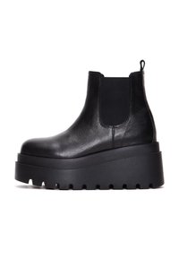 Black leather chelsea boots with elastic side panels, thick platform sole, and textured upper for added grip.