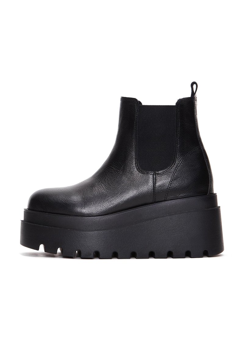 Black leather chelsea boots with elastic side panels, thick platform sole, and textured upper for added grip.