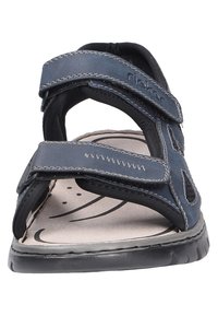 Navy blue sandal with dual Velcro straps, cushioned insole, and textured rubber outsole. Features perforated side panels and contrasting stitching.