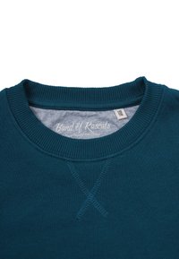 Turkos sweatshirt med rund ribbad halsringning och en X-stitch detalj fram. Inre etikett med texten "Band of Rascals" och storleksinformation.