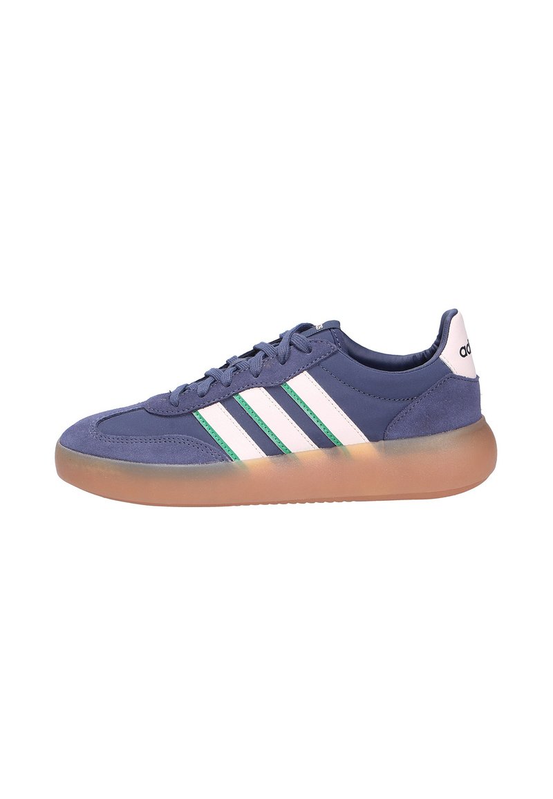 Blue Adidas sneaker with white and green stripes, gum sole, lace-up design, and white heel tab with Adidas logo.