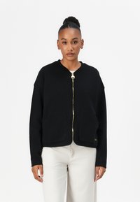 Schwarze Zip-up Sweatjacke aus weichem Stoff, mit rundem Ausschnitt, zwei Fronttaschen und goldenen Reißverschlussbeschlägen.