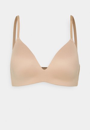 Beige triangle bra with adjustable straps, smooth texture, and a seamless design. Simple and functional with no embellishments.