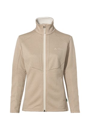 Hellbeige Reißverschlussjacke mit einem strukturierten Wabenmuster, hohem Kragen und weißen Reißverschluss. Mit Logo auf der linken Brust und einem grünen Akzentanhänger.