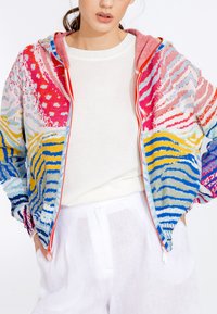 Colorful zip-up jacket featuring a mix of pink, blue, yellow, and white patterns. Made from knit material with a hood and elastic cuffs.