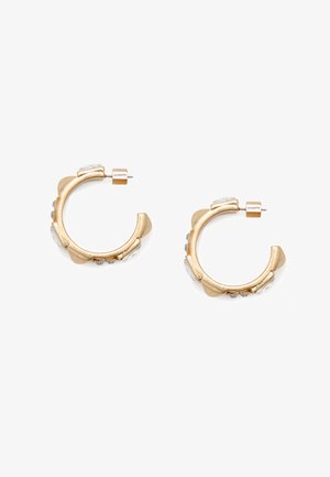 Gold hoop earrings featuring a textured design with clear accent stones. The hardware shows a small logo detail. Circular shape.