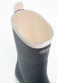 Viking gumová boot s hladkým tmavomodrým vonkajším povrchom, textúrovaným béžovým vnútorným povrchom a bielym pruhovaným okrajom okolo hornej hrany.