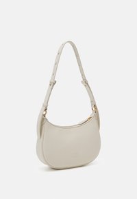 Cream leather shoulder bag with a curved shape, adjustable strap, and gold-tone hardware. Features a subtle embossed logo and zip closure.