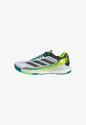 Gray and black athletic shoe with green accents and mesh upper. Features three black stripes and a textured sole for traction.