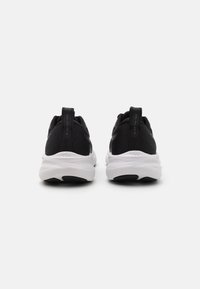 Black athletic shoes with a textured mesh upper, white cushioning midsole, and black rubber outsole. Features pull tabs at the back.